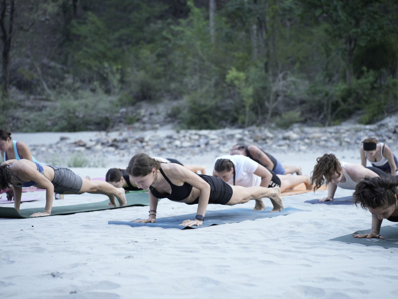Mastering the First Impression: Your intriguing post title goes here A group practicing yoga on a beach in Bali, Indonesia, surrounded by lush greenery.